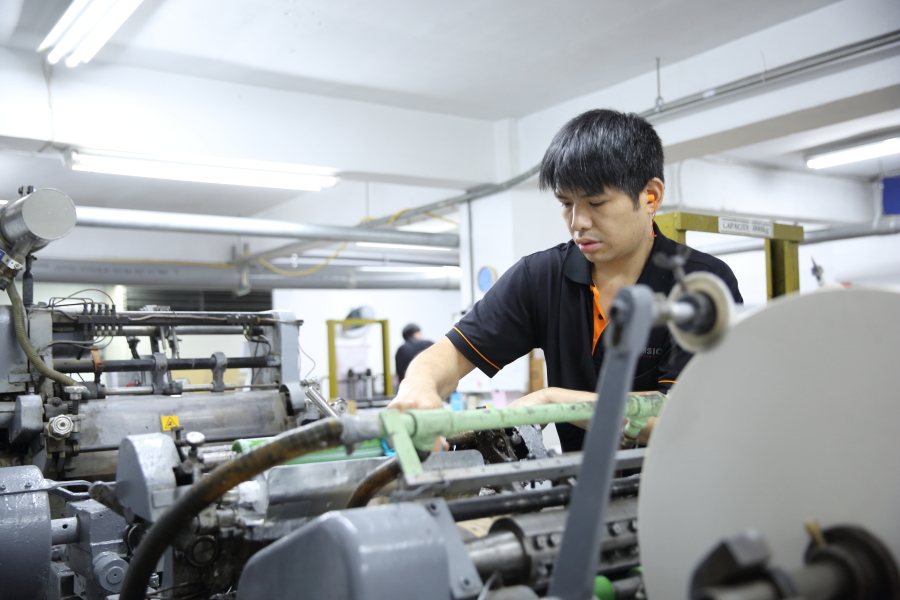 A machine adjuster in Tension's Taiwan facility performs a changeover in this picture from 2014.
